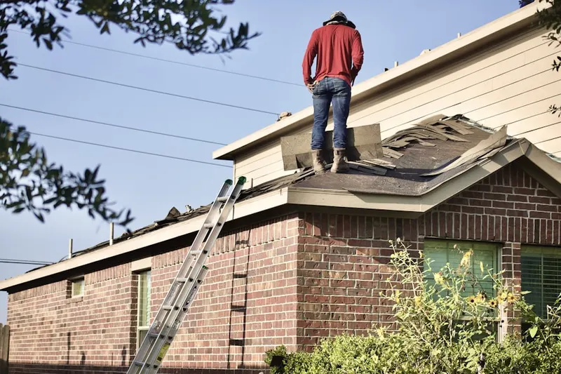 Professional roofer working on a residential roof in Logan Creek Estates